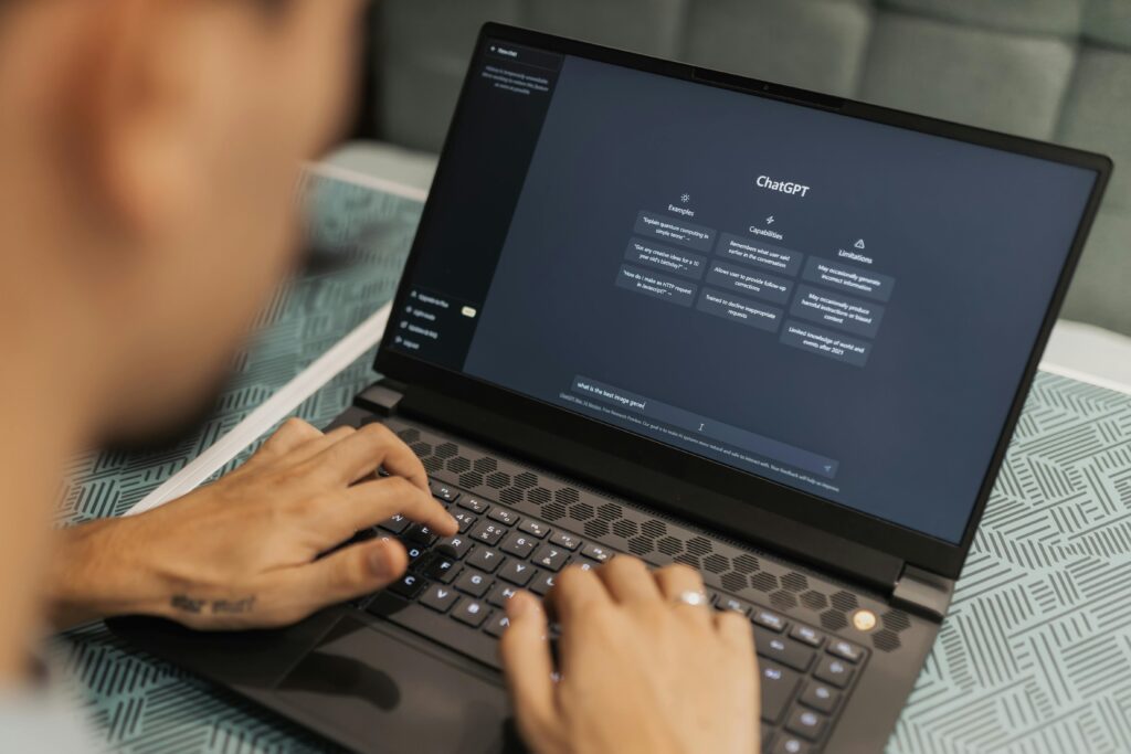 Hands typing on a laptop showing ChatGPT on the screen. Public domain. Matheus Bertelli, Pexels.